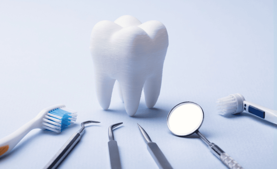 Dental tools with toothbrush and tooth model on a blue background